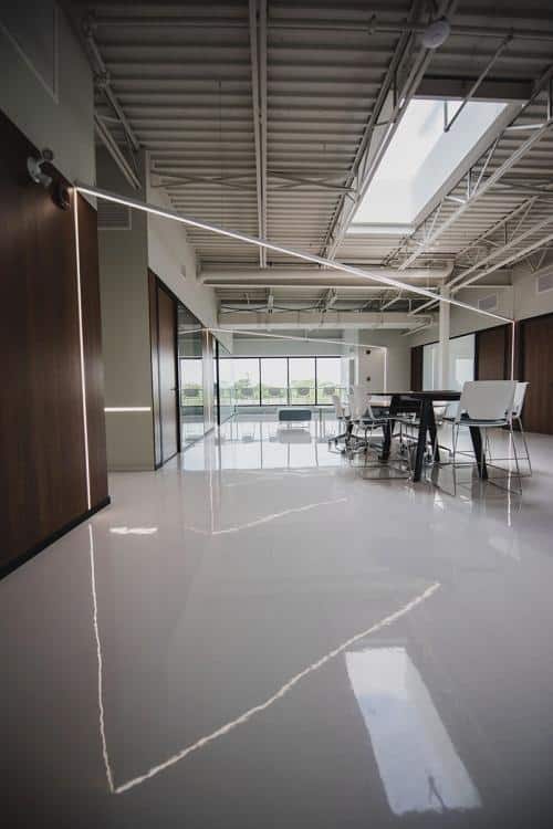 Wetstyle office with linear LED and recessed LED lighting.